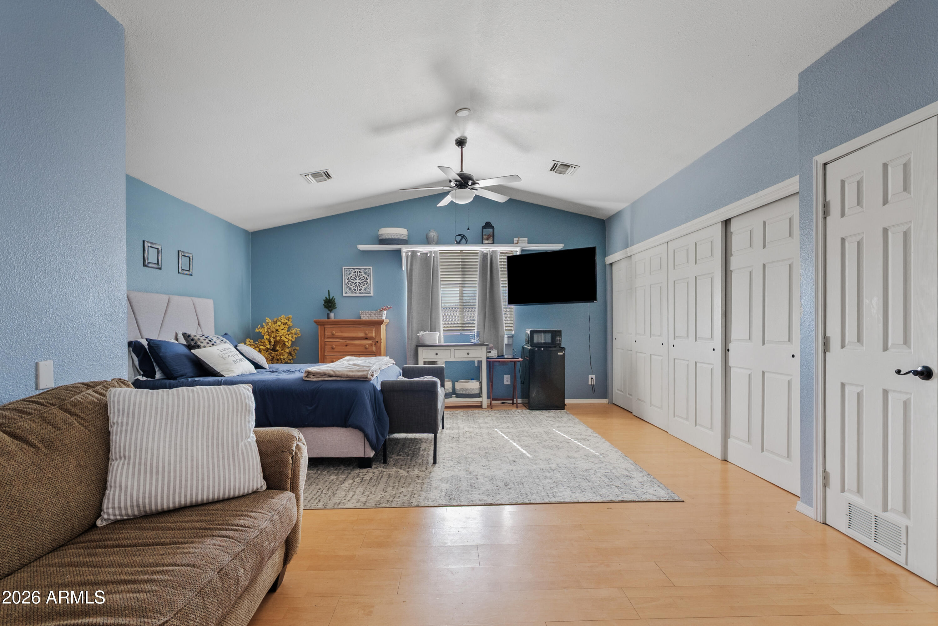 550 South Oak Street Gilbert, AZ 85233 - Photo 36 of 41 a living room with furniture a fireplace and a flat screen tv