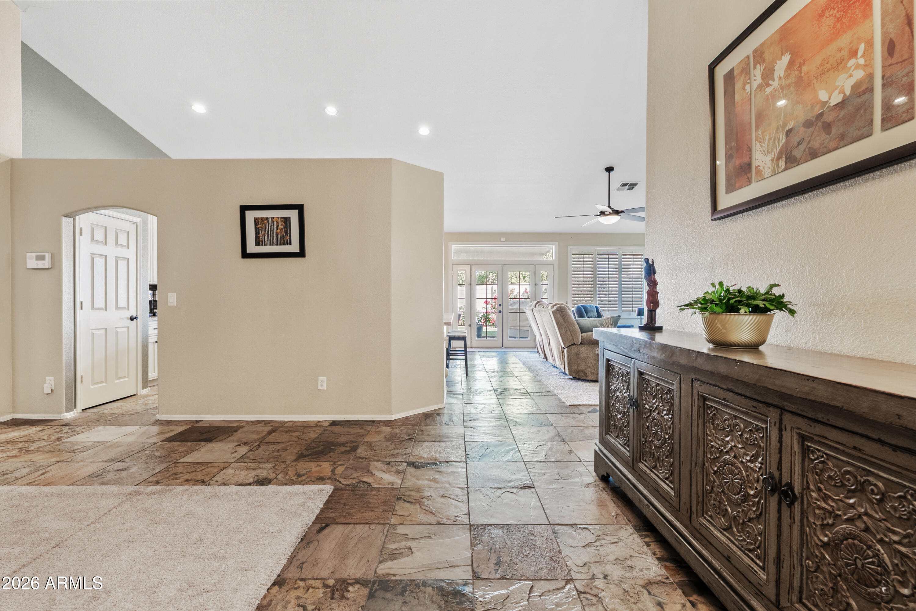 550 South Oak Street Gilbert, AZ 85233 - Photo 4 of 41 a kitchen with stainless steel appliances granite countertop a refrigerator a sink dishwasher and white cabinets with wooden floor