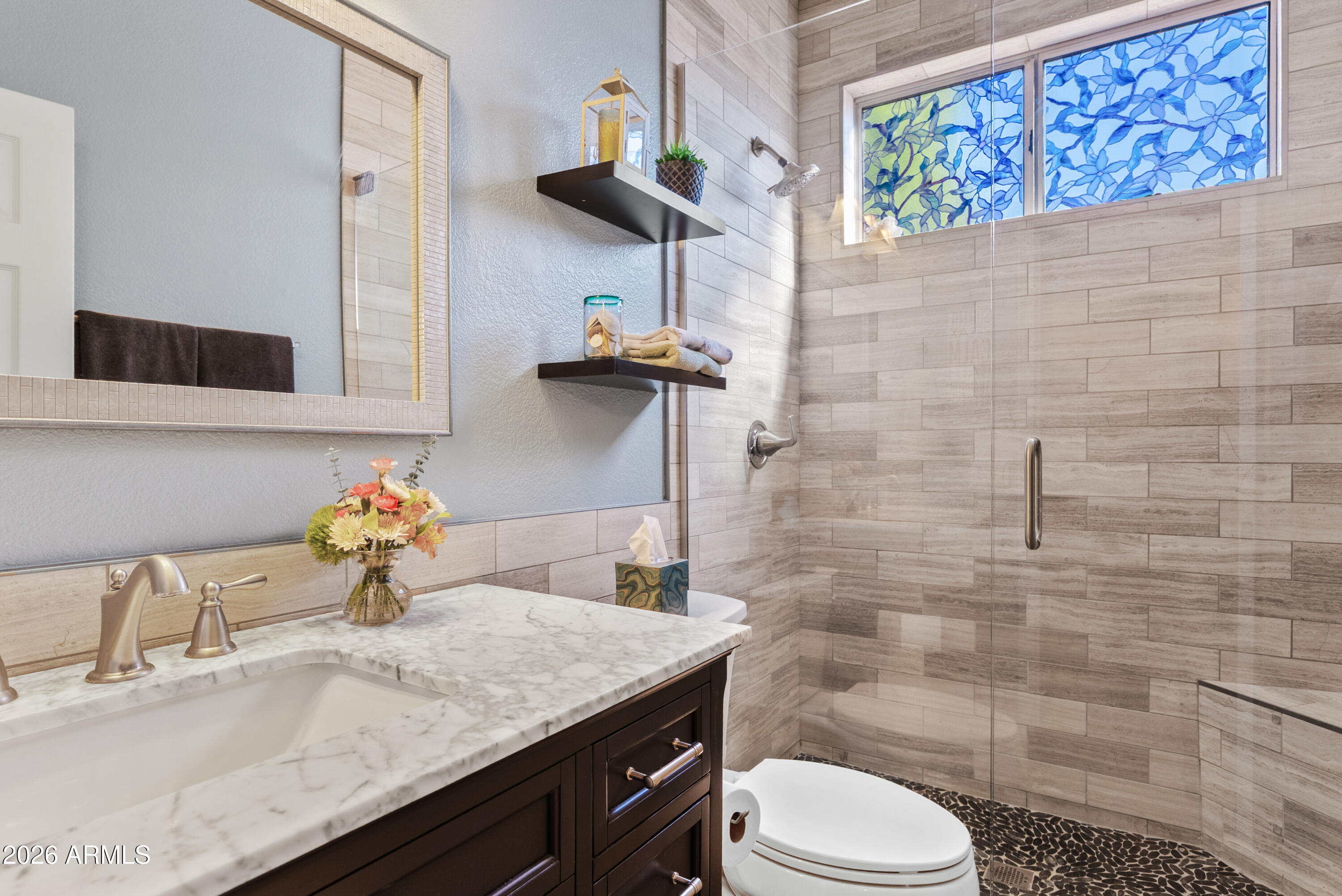 550 South Oak Street Gilbert, AZ 85233 - Photo 5 of 41 a bathroom with a granite countertop toilet sink and mirror