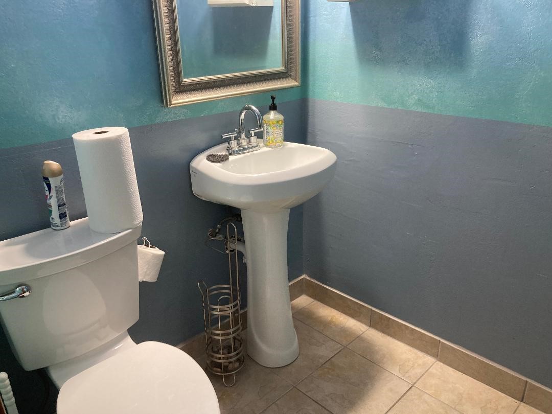 11001 Fondren Road, Unit A Houston, TX 77096 - Photo 9 of 15 a bathroom with a toilet sink and mirror