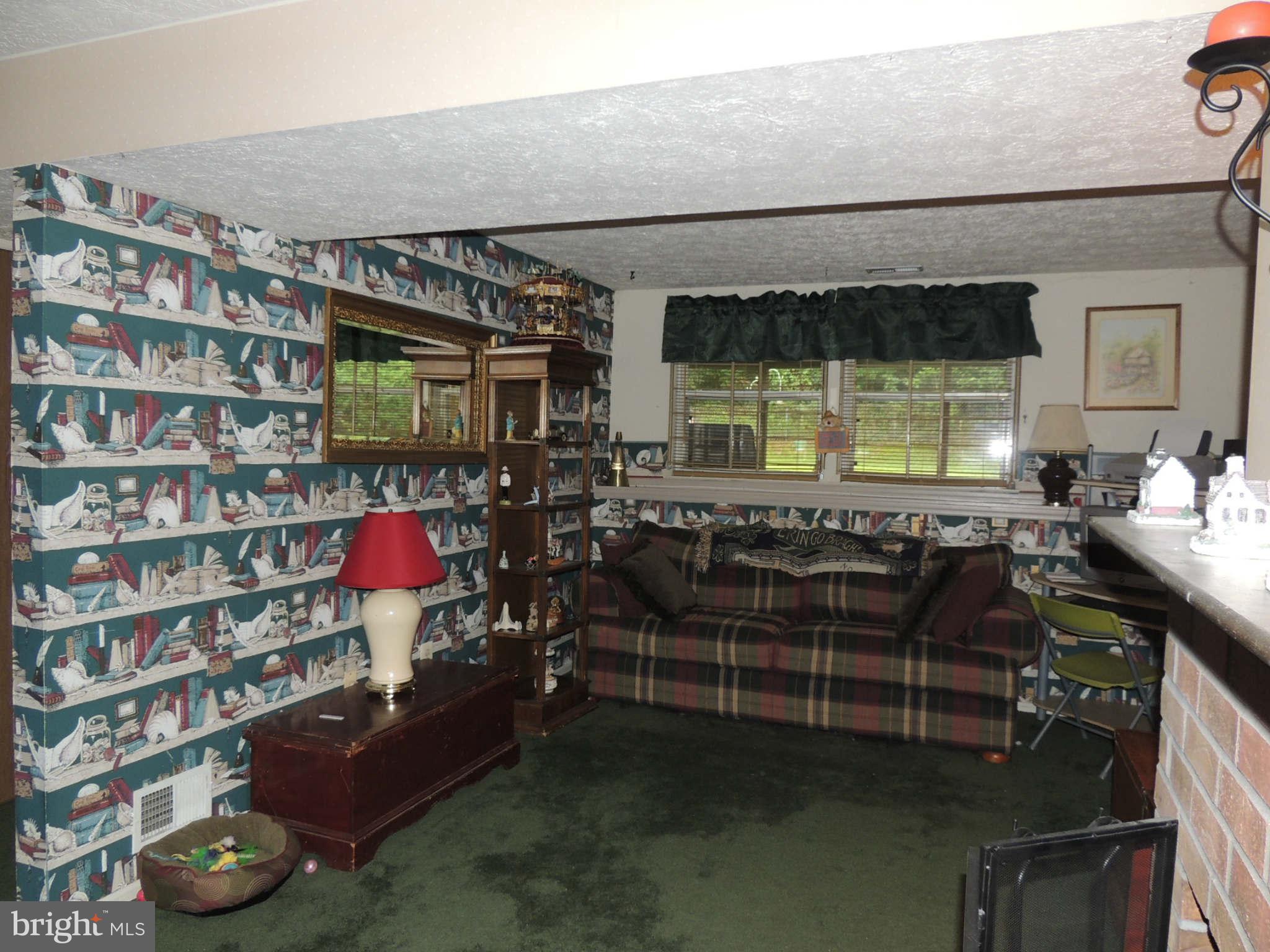 35 Yew Road Baltimore, MD 21221 - Photo 22 of 30 a living room with furniture a flat screen tv and floor to ceiling window