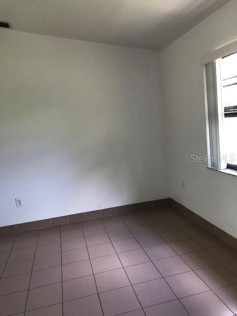 25385 Sandhill Boulevard, Unit E1 Punta Gorda, FL 33983 - Photo 13 of 16 an empty room with a window