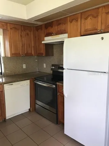 a kitchen with a refrigerator and a stove