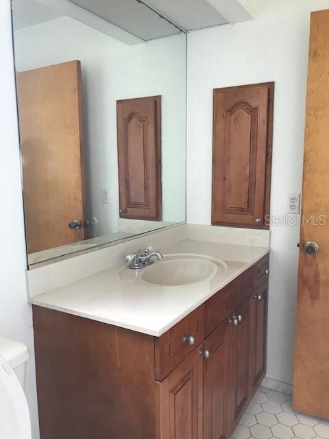 25385 Sandhill Boulevard, Unit E1 Punta Gorda, FL 33983 - Photo 7 of 16 a bathroom with a sink and a mirror