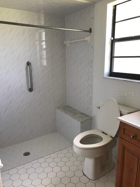 25385 Sandhill Boulevard, Unit E1 Punta Gorda, FL 33983 - Photo 8 of 16 a white toilet sitting next to a shower