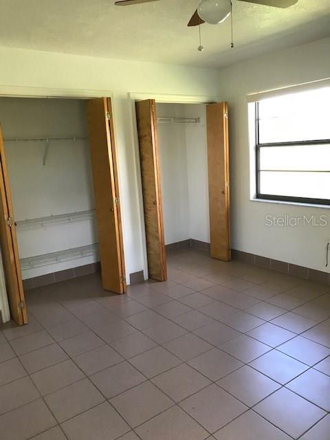 25385 Sandhill Boulevard, Unit E1 Punta Gorda, FL 33983 - Photo 9 of 16 a view of an empty room with windows