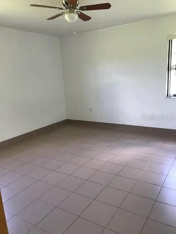 a view of an empty room and a window