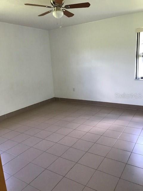 25385 Sandhill Boulevard, Unit E1 Punta Gorda, FL 33983 - Photo 10 of 16 a view of an empty room and a window