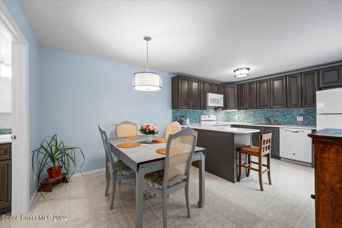 2012 Dan Court Palm Bay, FL 32905 - Photo 15 of 22 a kitchen with a table and chairs in it