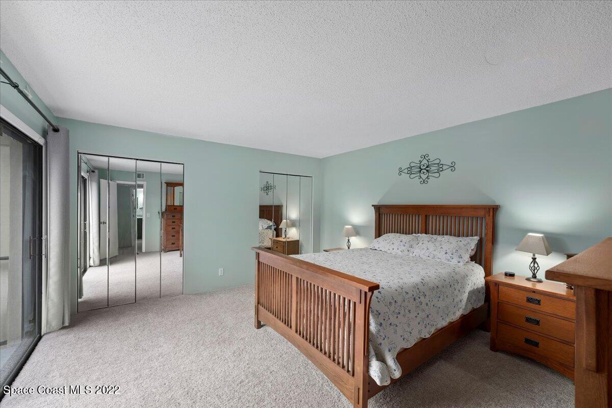 2012 Dan Court Palm Bay, FL 32905 - Photo 18 of 22 a bedroom with a bed and a walk in closet