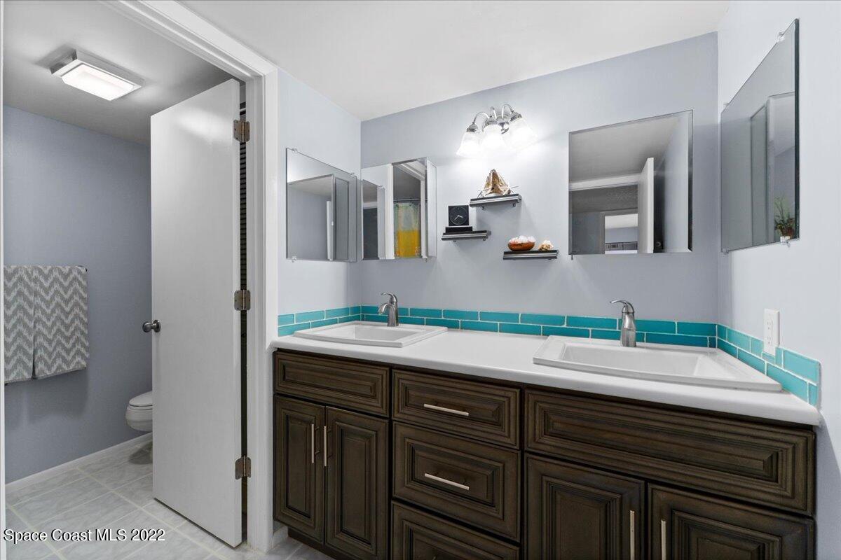 2012 Dan Court Palm Bay, FL 32905 - Photo 21 of 22 a bathroom with a sink and a mirror