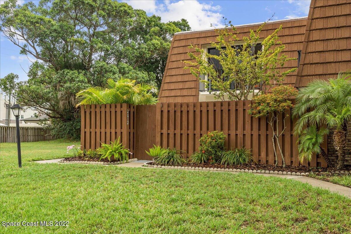 2012 Dan Court Palm Bay, FL 32905 - Photo 3 of 22 a view of a backyard with potted plants and large tree