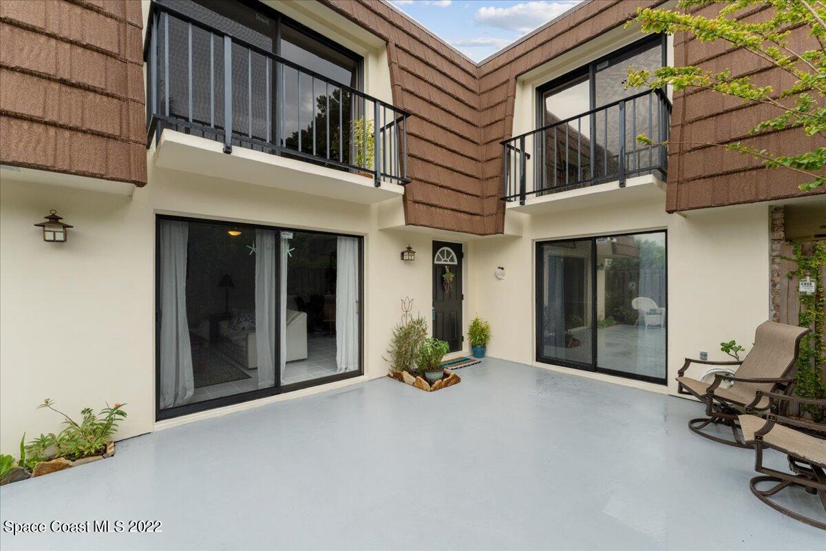 2012 Dan Court Palm Bay, FL 32905 - Photo 5 of 22 a view of a building with chair and a potted plant