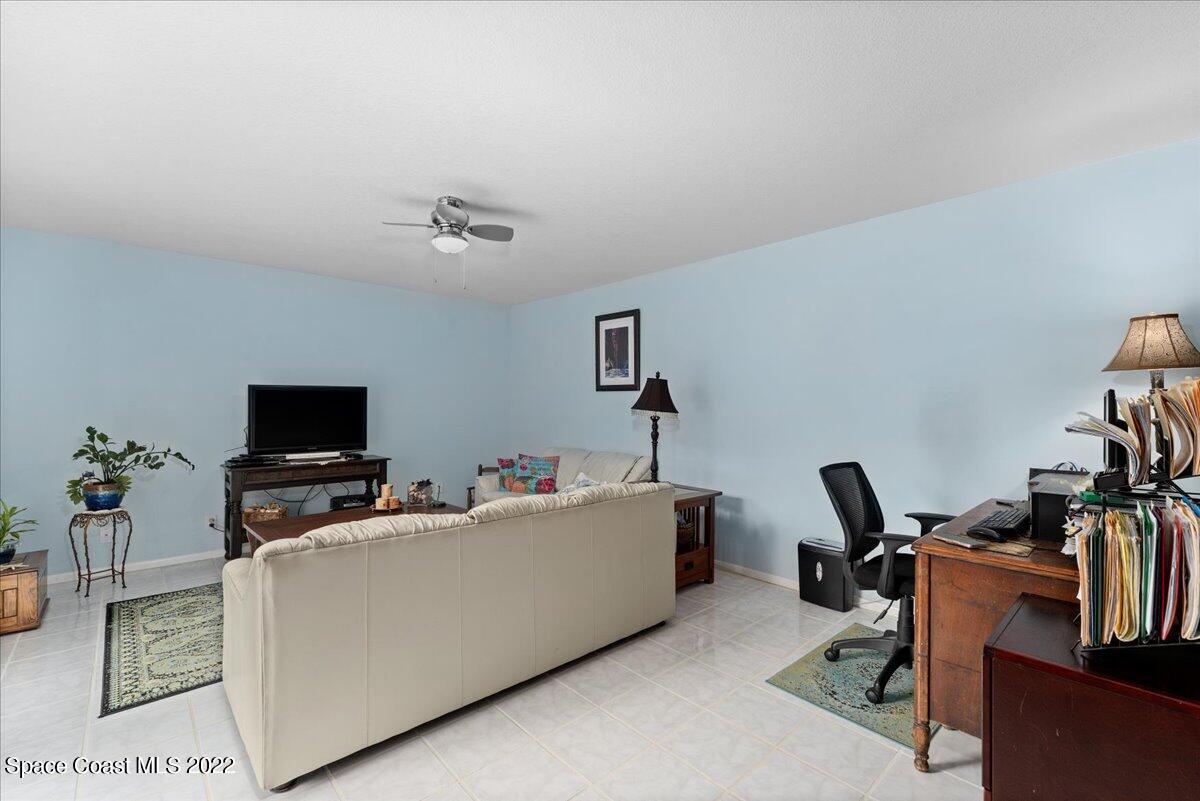 2012 Dan Court Palm Bay, FL 32905 - Photo 8 of 22 a living room with furniture and a flat screen tv