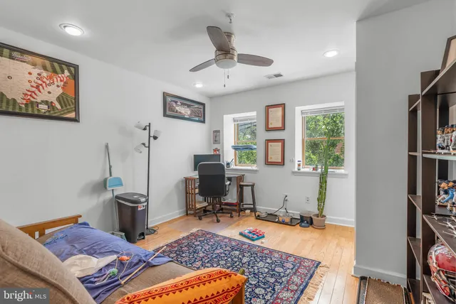 a bedroom with furniture and a rug