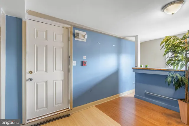 a view of an entryway with wooden floor