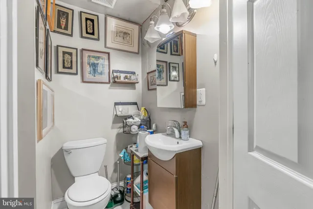 a bathroom with a toilet sink and mirror