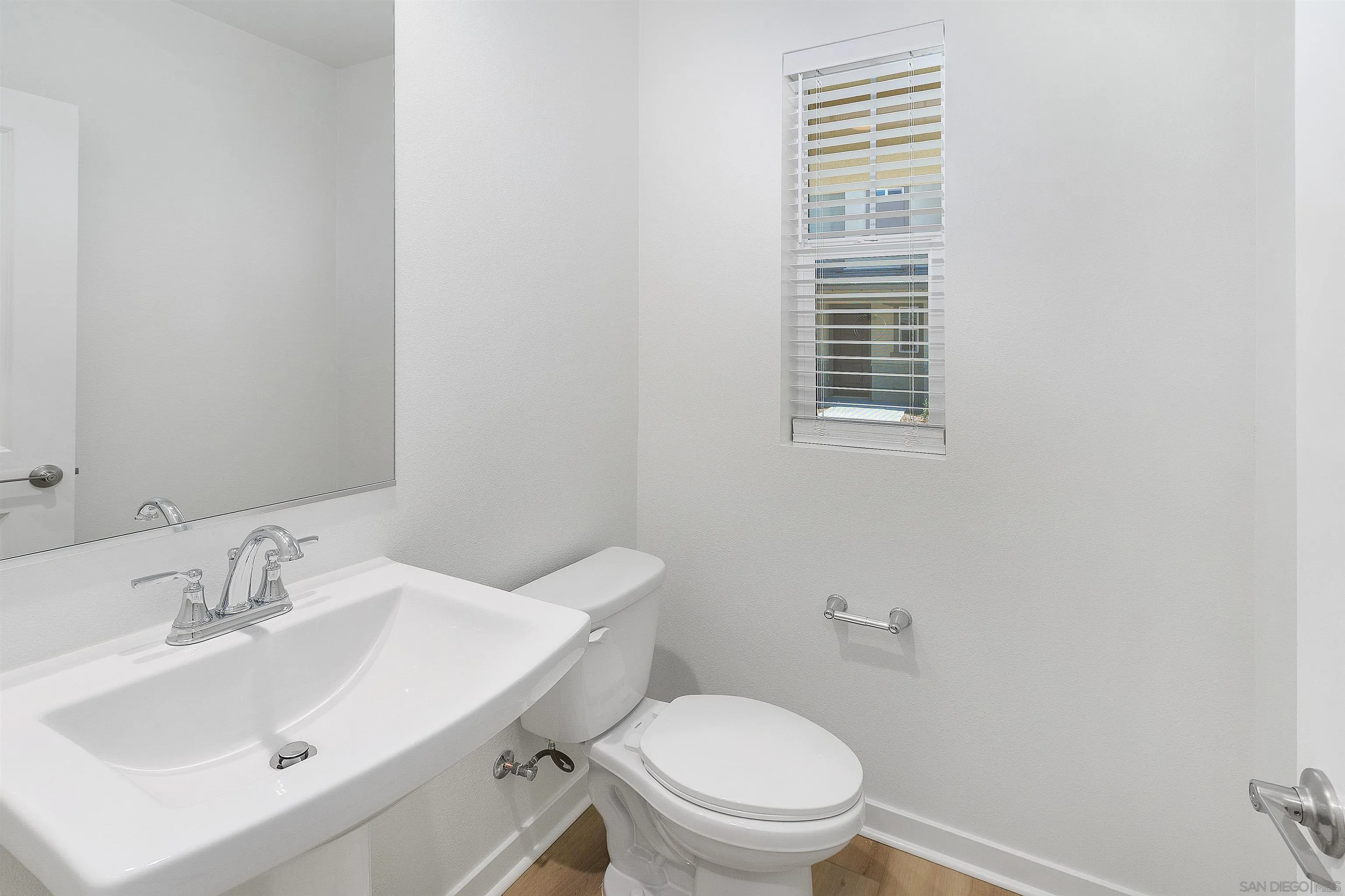 32336 Brunello Way Temecula, CA 92591 - Photo 18 of 26 a bathroom with a sink a toilet and a mirror