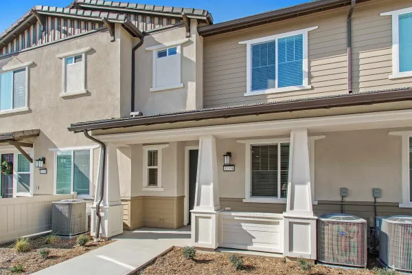 a front view of a house with many windows
