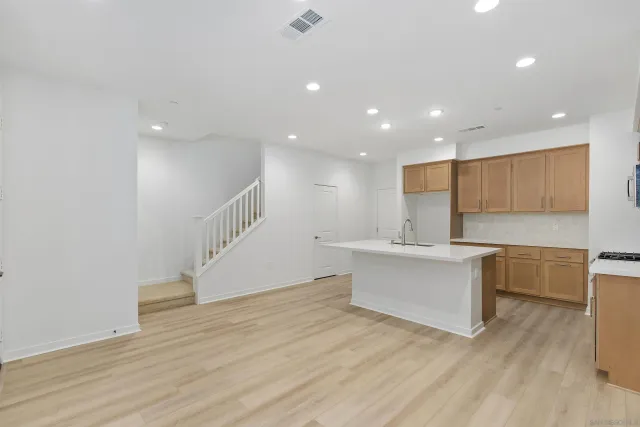 a view of kitchen with cabinets and wooden floor