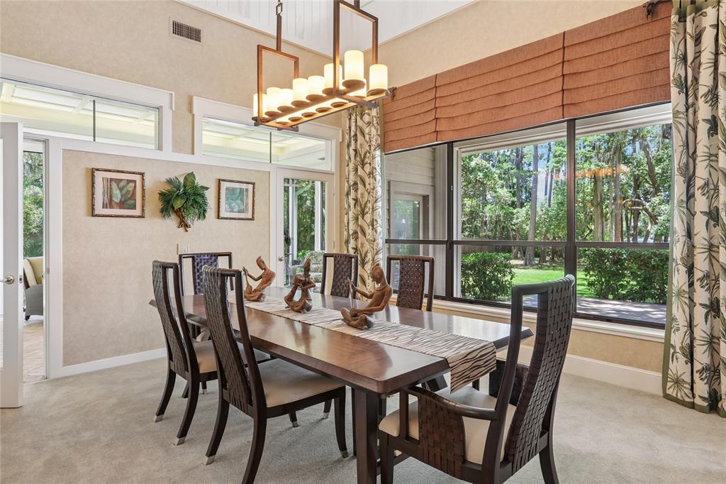 17810 Crawley Road Odessa, FL 33556 - Photo 15 of 76 a view of a dining room with furniture wooden floor and a chandelier