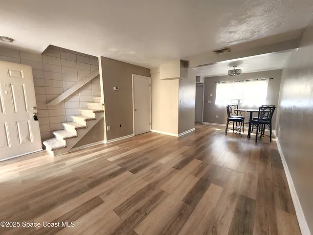 a view of a livingroom with furniture and wooden floor
