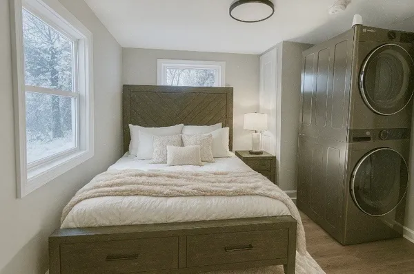 a bedroom with a bed and a window