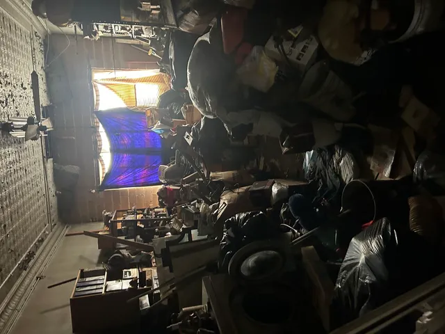 a room with water heater and wooden cabinets