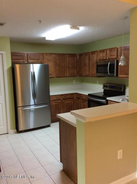 7920 Merrill Road, Unit 1009 Jacksonville, FL 32277 - Photo 2 of 22 a kitchen with a refrigerator and a sink