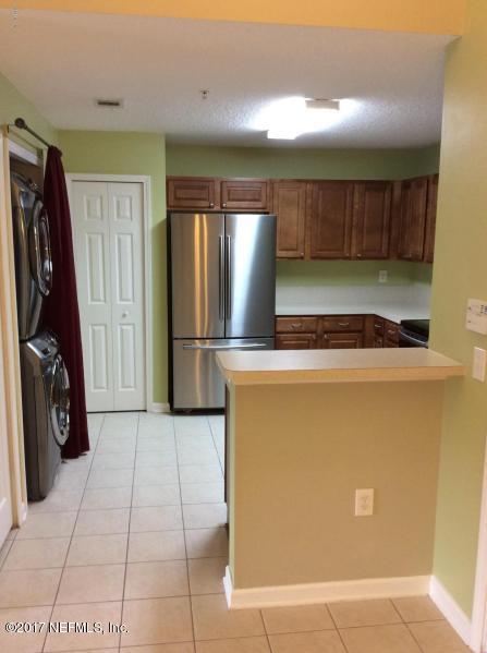 7920 Merrill Road, Unit 1009 Jacksonville, FL 32277 - Photo 3 of 22 a view of a refrigerator in kitchen and a window