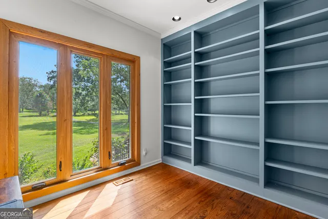 a spacious bathroom with a granite countertop sink and a mirror