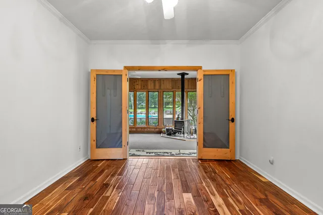 a living room with a fireplace windows and a wooden floor
