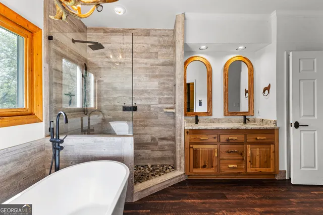 a living room with furniture and floor to ceiling windows