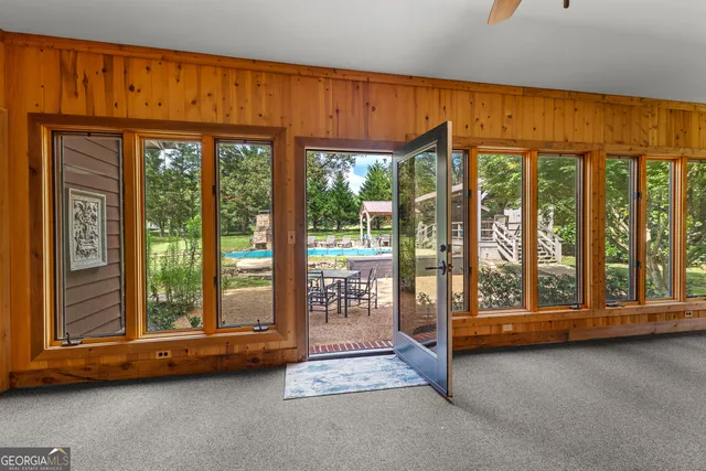 a bathroom with a granite countertop sink toilet and a window