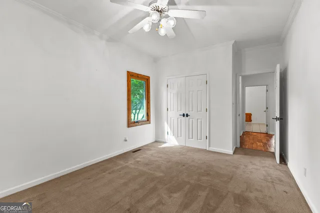 a view of a swimming pool with a lounge chair and a small yard