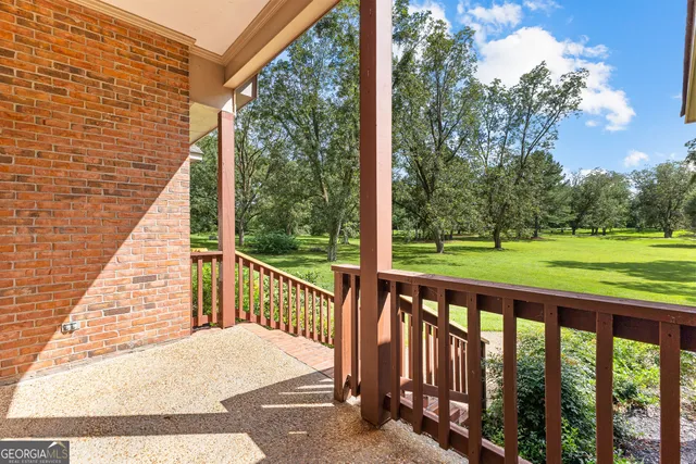 a view of a room with wooden floor and white walls