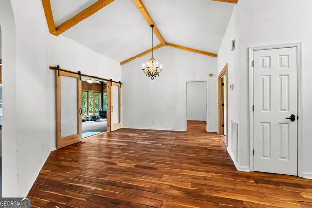 a view of a room with wooden floor and fan