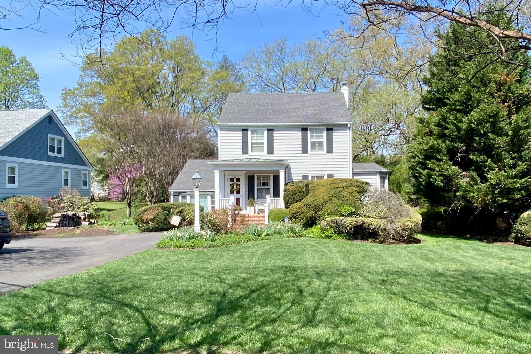 a front view of a house with a yard and potted plants