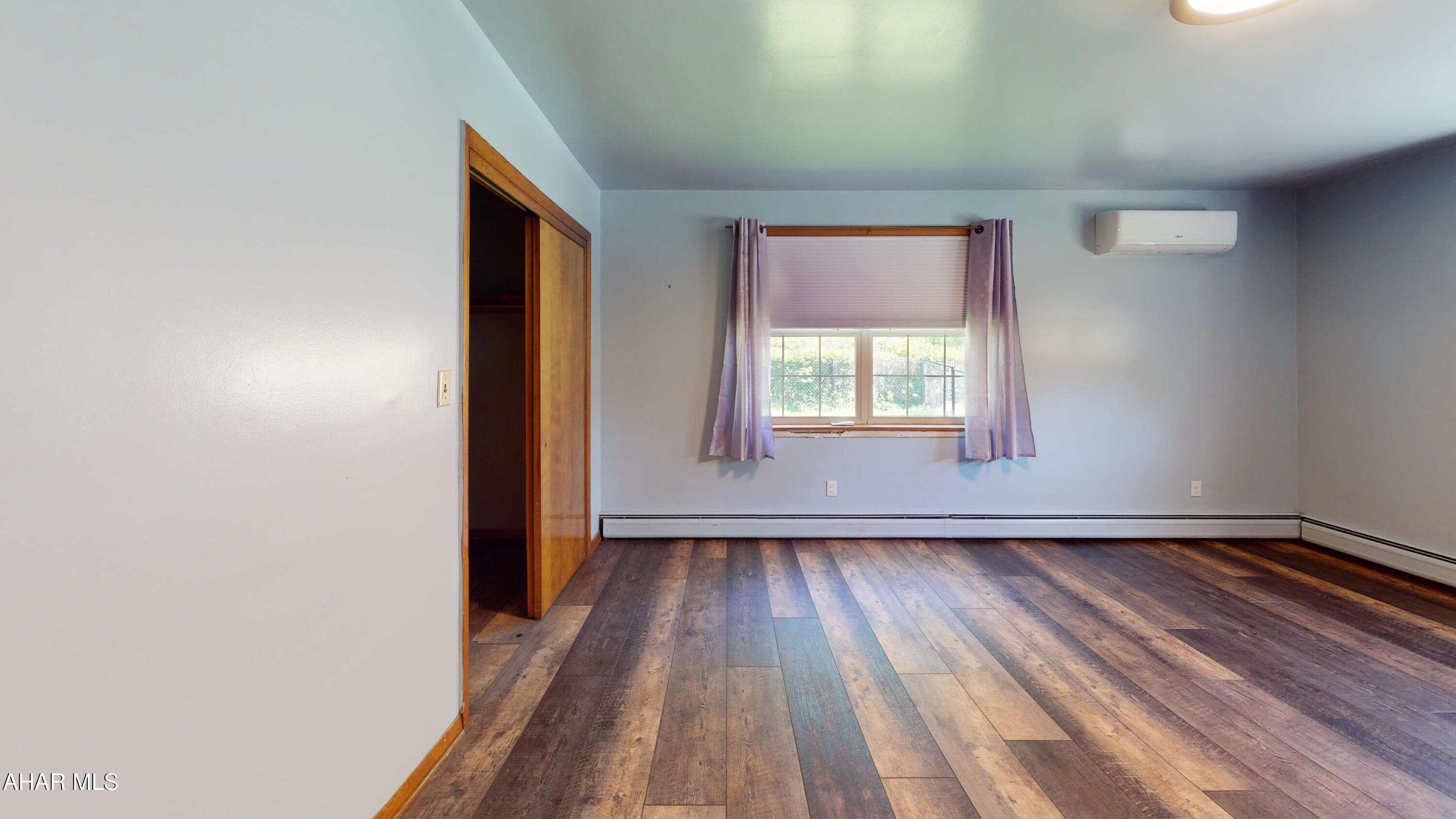 871 Decker Hollow Road Tyrone, PA 16686 - Photo 25 of 35 an empty room with wooden floor and windows