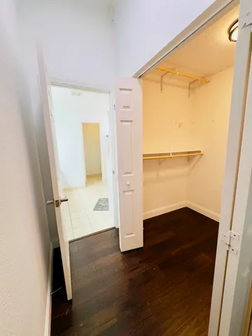 a view of storage and utility room with wooden floor