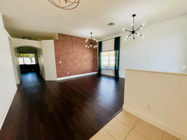a view of livingroom with hallway and wooden floor