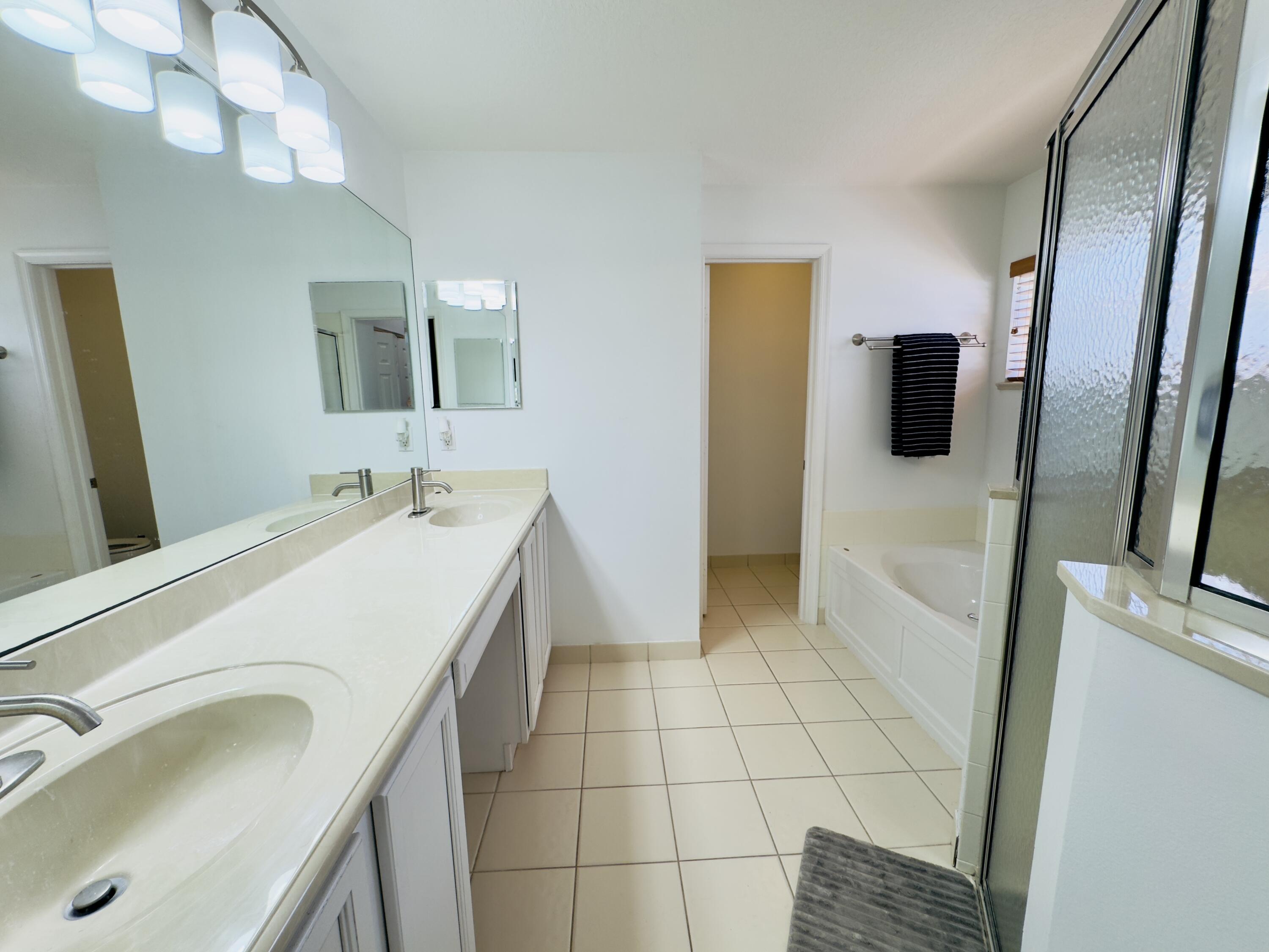 11479 Southwest Glengarry Court Port St. Lucie, FL 34987 - Photo 21 of 24 a bathroom with a sink a toilet and mirror