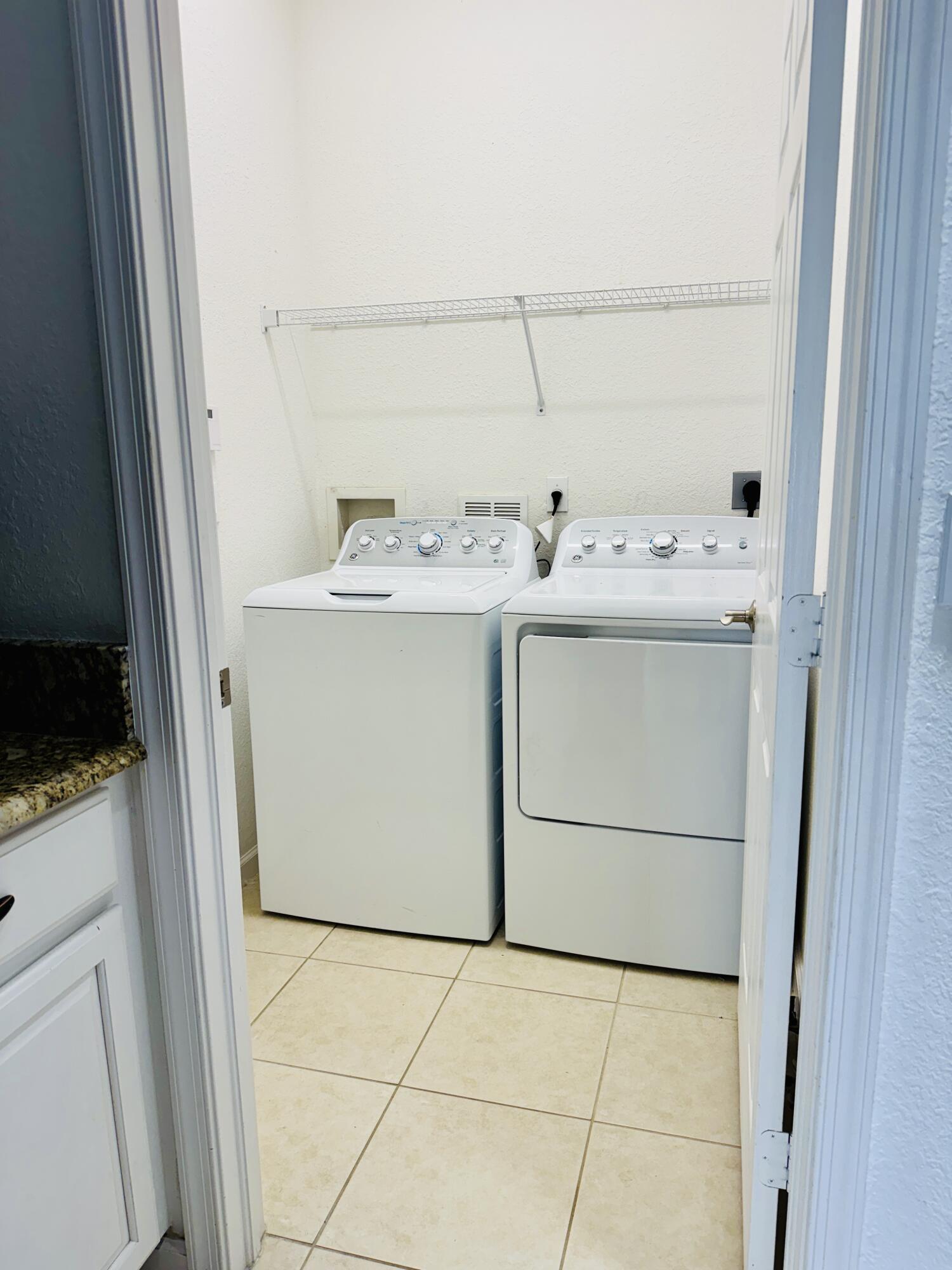 11479 Southwest Glengarry Court Port St. Lucie, FL 34987 - Photo 22 of 24 a utility room with dryer and washer