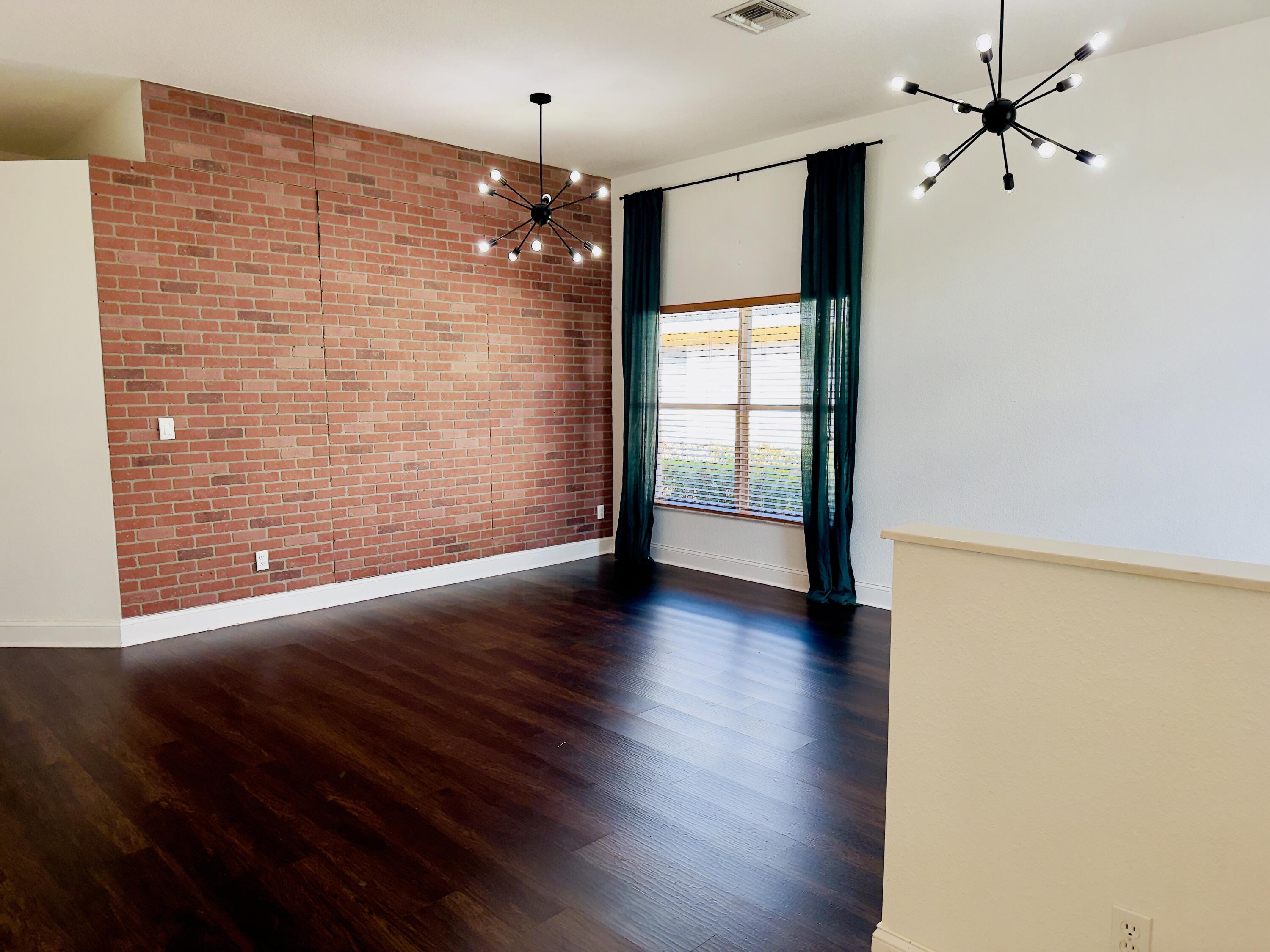 11479 Southwest Glengarry Court Port St. Lucie, FL 34987 - Photo 3 of 24 a view of empty room with wooden floor and fan