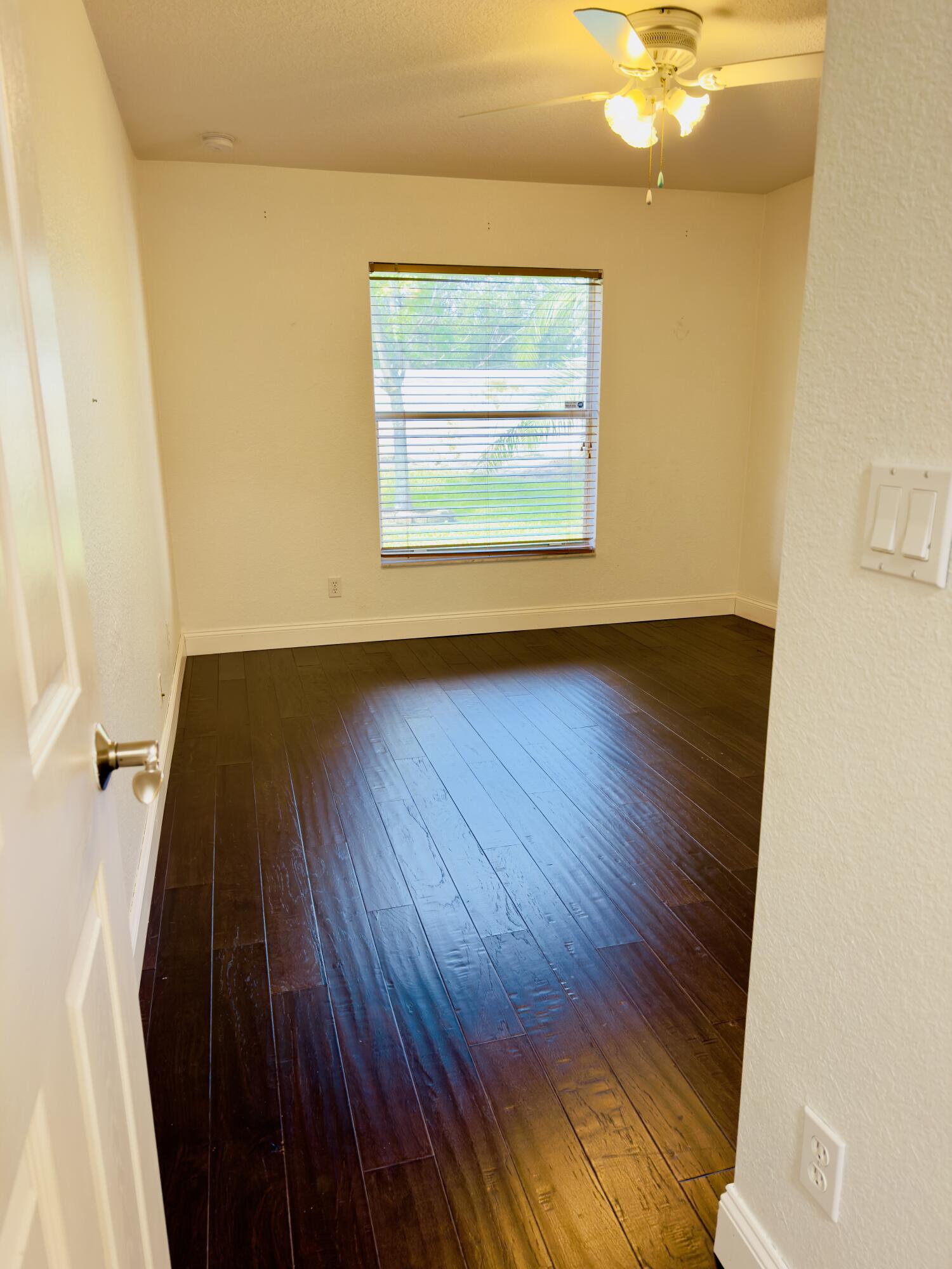 11479 Southwest Glengarry Court Port St. Lucie, FL 34987 - Photo 10 of 24 a view of a room with wooden floor and window