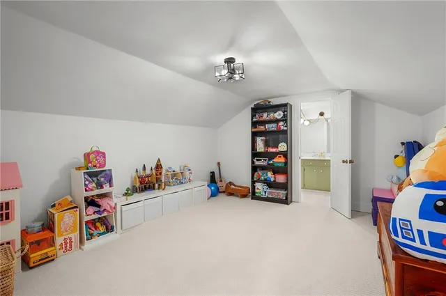 a bathroom with a granite countertop sink a light fixture and a mirror