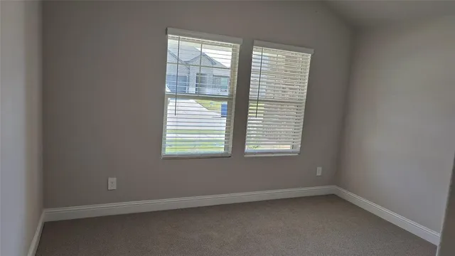 a view of a house with a fence