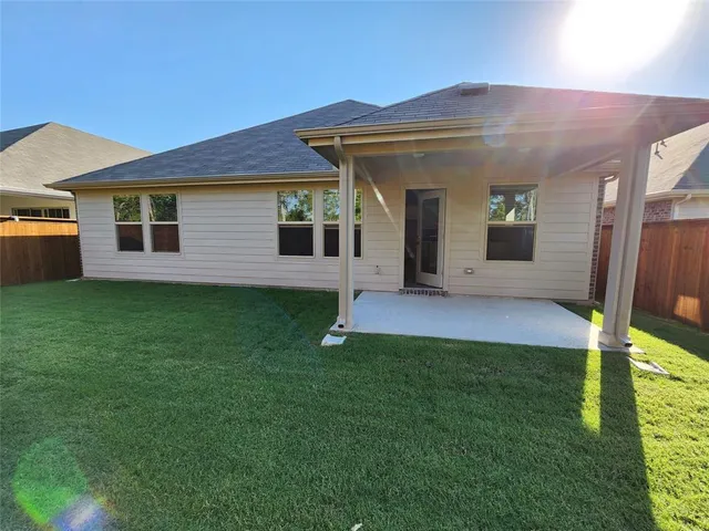 a front view of a house with a yard and table and chairs