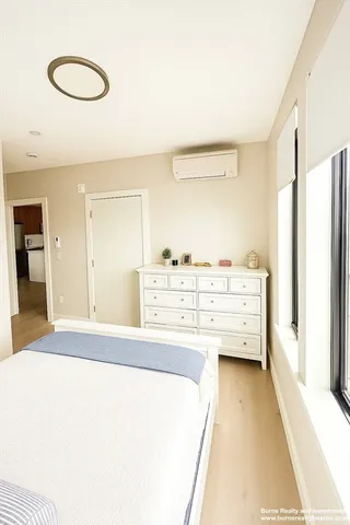 a room with a bed and cabinets