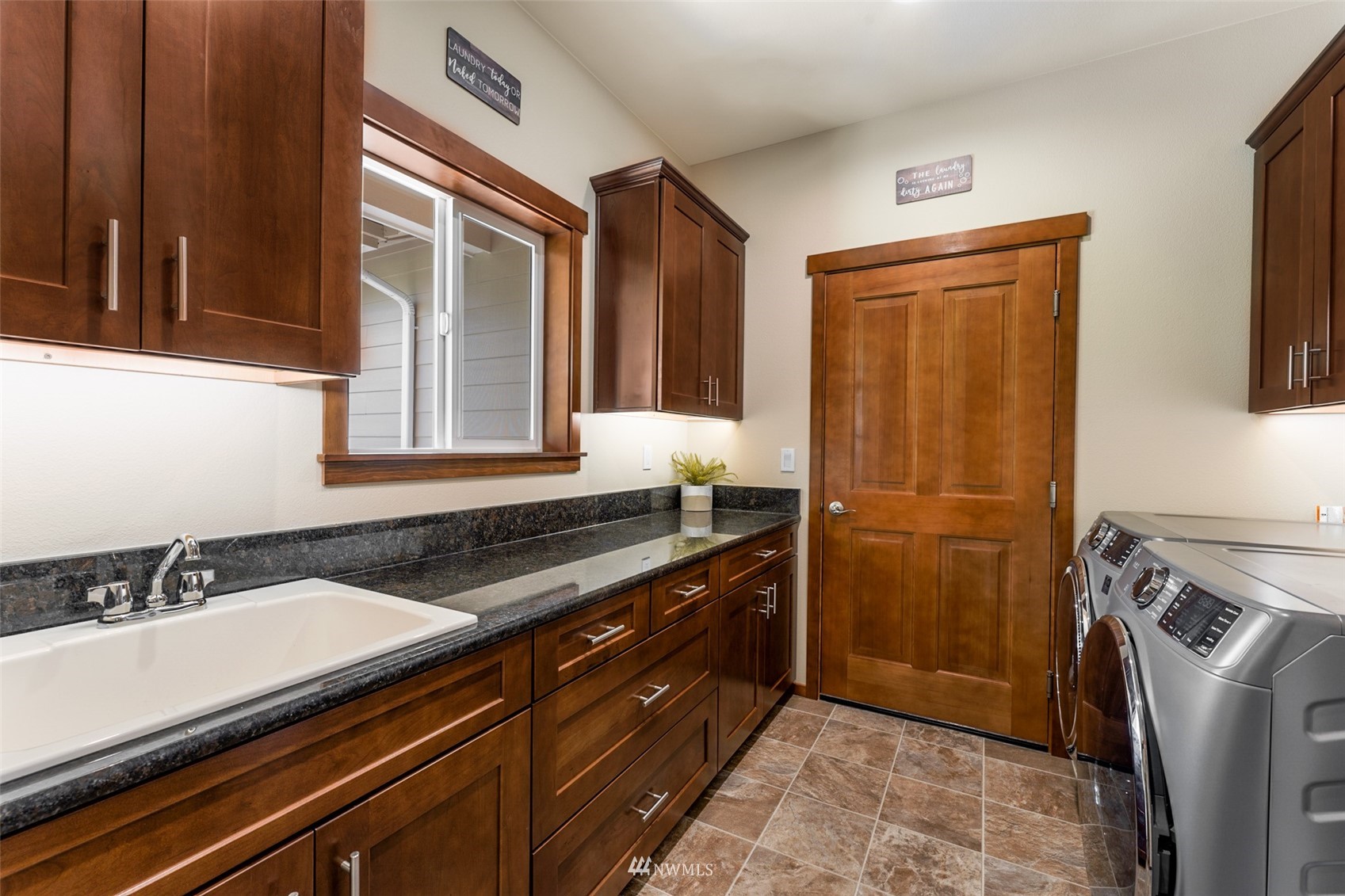 81 East Lighthouse Road Shelton, WA 98584 - Photo 19 of 28 a kitchen with a sink and a refrigerator